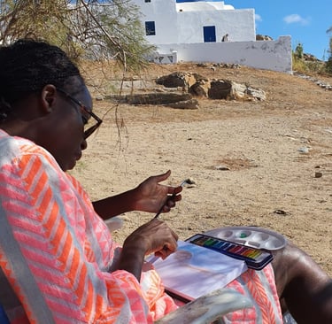 a group participant painting by the beach