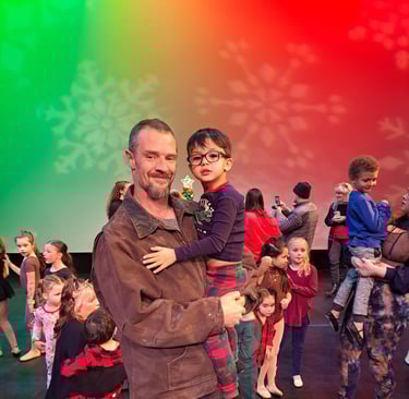 a man and a child are standing in front of a colorful background
