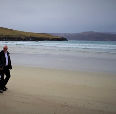 a wedding couple walking on a beach