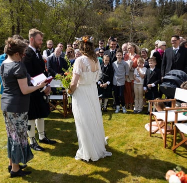 a bride and groom are standing in front of a crowd of people