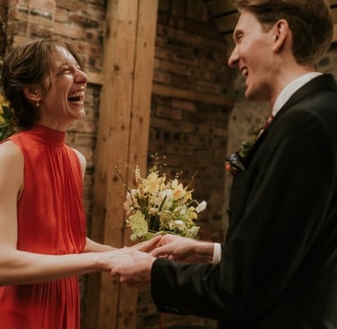 a man and woman holding hands and smiling