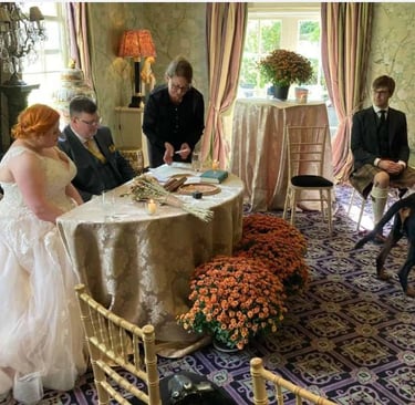 a bride and groom are sitting at a table