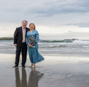 a man and woman standing on a beach after a wedding