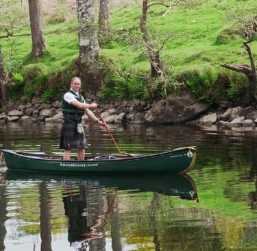 a man in a green canoe on a river