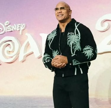 a man in a black shirt and sunglasses standing in front of a sign that says