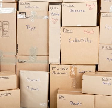 Swift Movers packed boxes showing careful packing of household items like books, dishes, and clothes