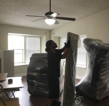 Swift Movers crew wrapping furniture with padding for safe and efficient residential moving