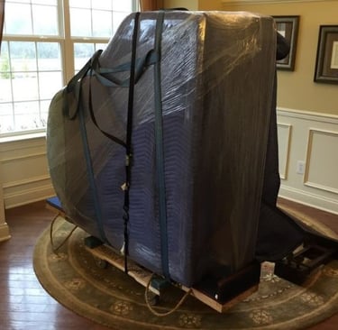 Grand piano prepped for moving by Swift Movers’ experienced heavy item team