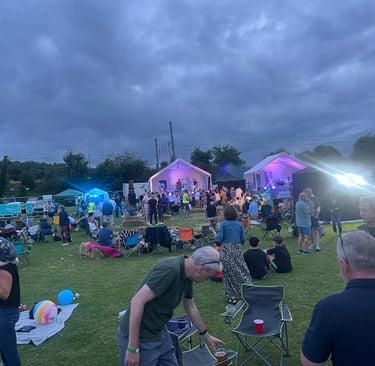 Parting in an outside festival field at Woolmer Green