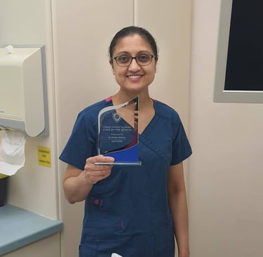 a woman in scrubs and scrubs holding a plaque
