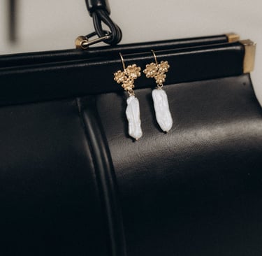 a purse with a pair of earrings and a purse