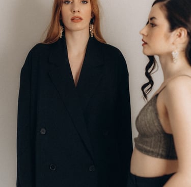 two women standing next to each other in a room
