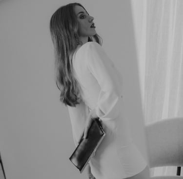a woman in a white dress and a black purse