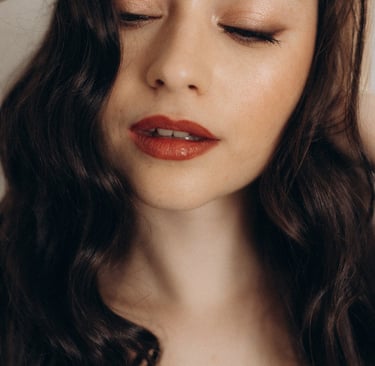 a woman with long hair and red lips.