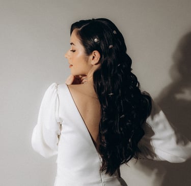 a woman in a white dress with a long sleeved dress