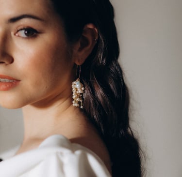 a woman with long hair and earrings on her head