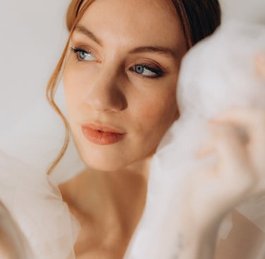 a woman in a white dress with a veil on her head