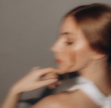 a woman in a white dress and a black tie