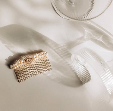 A barrette placed next to a glass of champagne.