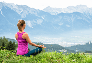 A woman meditating for mental and physical well-being.