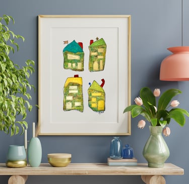 a picture of four whimiscal houses and a vase with flowers along with vases on a table