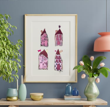 a picture of four whimiscal houses and a vase with flowers along with vases on a table