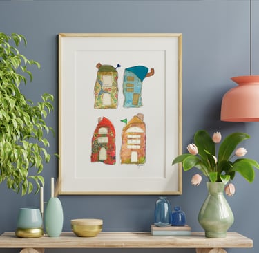 a picture of four whimiscal houses and a vase with flowers along with vases on a table