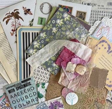 A collection of printed paper, book pages, ribbon, dyed tea bag, doily, transfer pieces