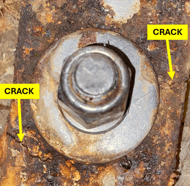 Close-up of cracked stainless steel chainplate on a cruising sailboat