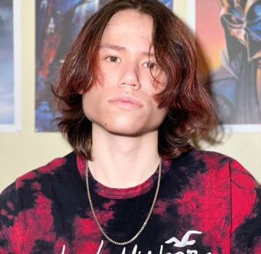 a man with long hair and a tie dye tshirt