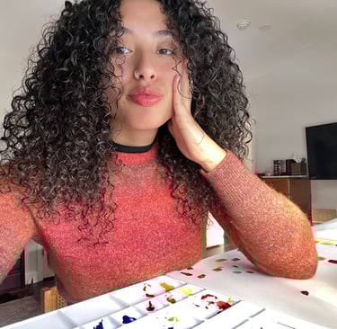 a woman with curly hair and a red sweater