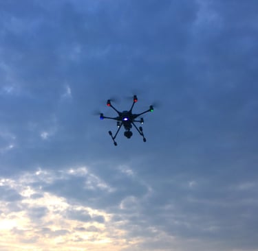 a small drone flying through the sky