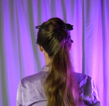 a woman with a ponytail in her hair