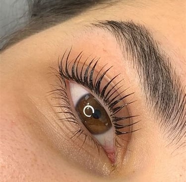 a woman with a large eyeliners and a pair of lashes