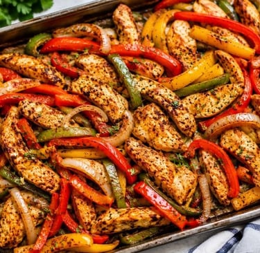 Easy Dump chicken fajitas with roasted bell peppers and onions on a baking tray.