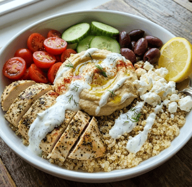 a bowl of greek chicken & hummas