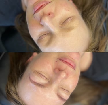 two people laying on a bed with their heads together
