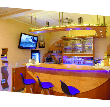 a hotelbar with a bar stool and a television