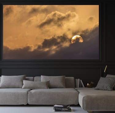 a couch with a large picture of the moon setting
