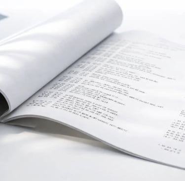 Open business report document showing financial data tables and printed spreadsheet pages.