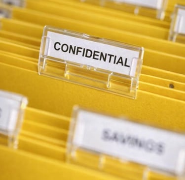 Yellow hanging file folders with a confidential label for secure document storage and organization.
