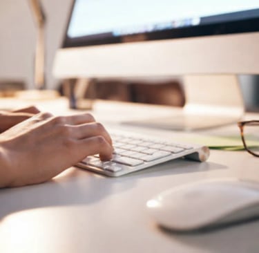 Person updating LinkedIn profile on a computer in bright office