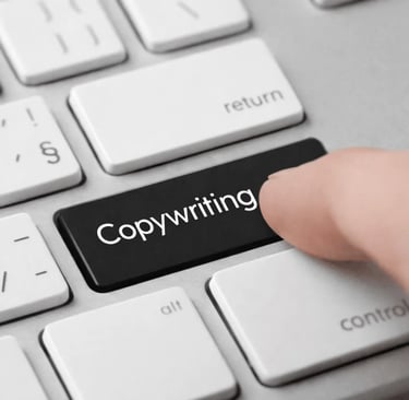 A finger pressing a black keyboard key with the word copywriting on a white laptop.
