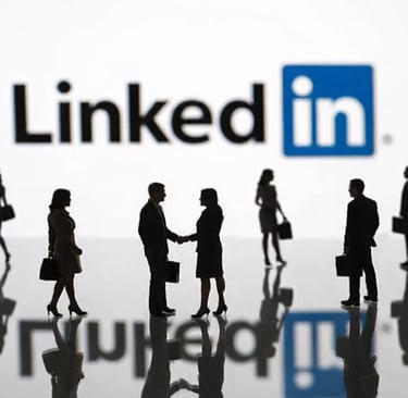 Silhouetted business professionals networking and shaking hands in front of a LinkedIn logo.