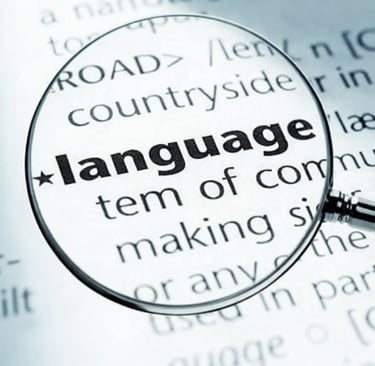 A magnifying glass focusing on the word language in a dictionary definition.