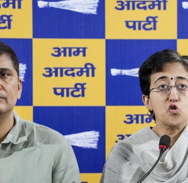 a man and woman sitting at a podium with a microphone