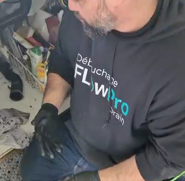 Professional drain cleaning technician operating high-pressure hydro-jet system