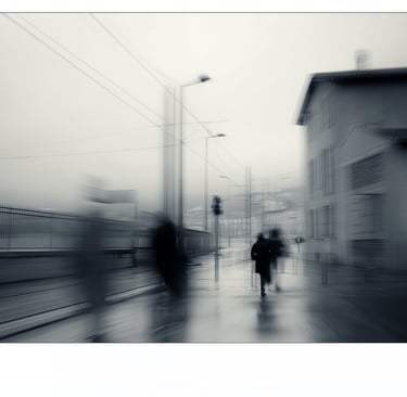 a blurry photo of people walking down a street