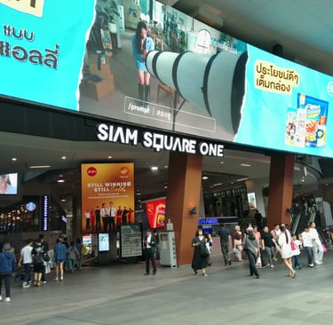 a group of people walking through a mall