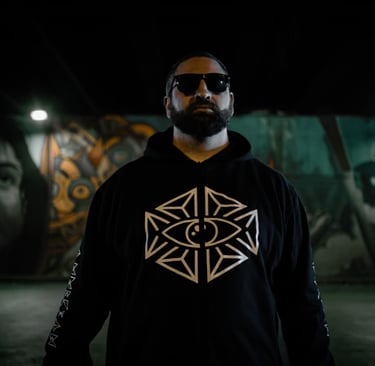 a man in a black hoodie and sunglasses